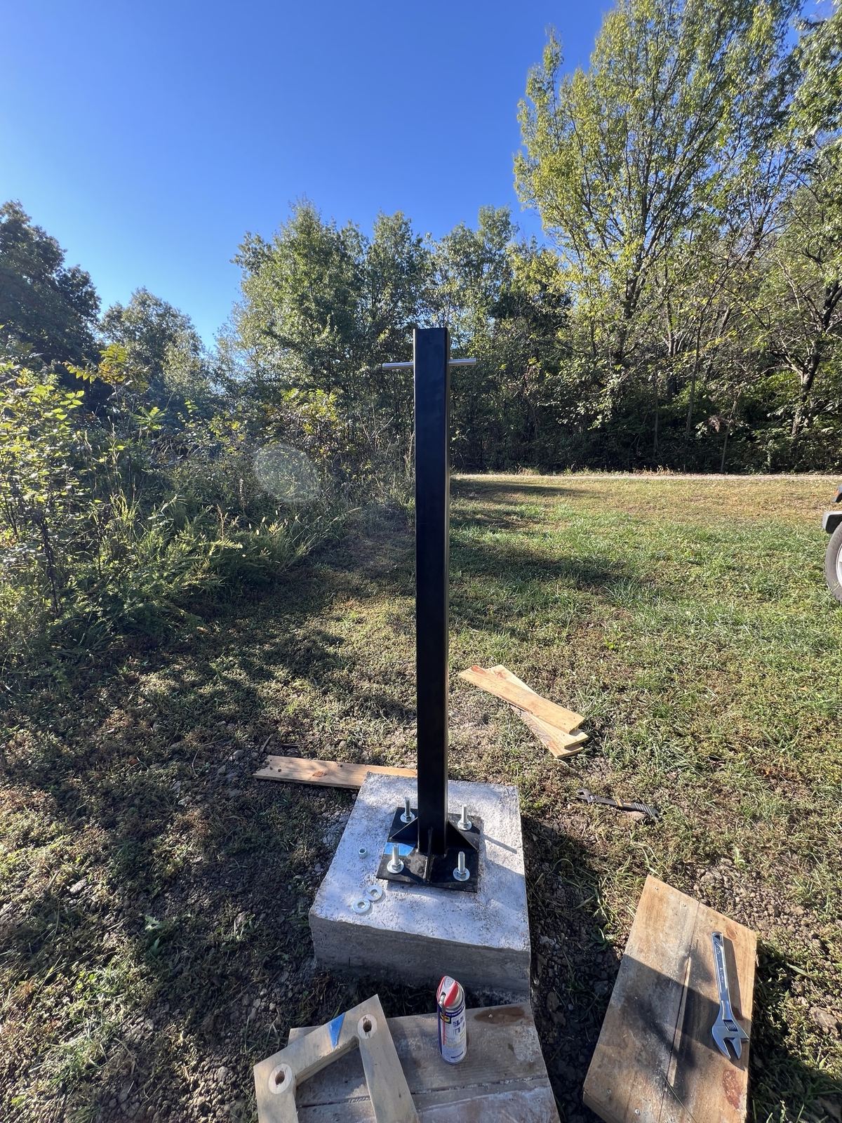 Steel mast bolted to the cured concrete pier in the field
